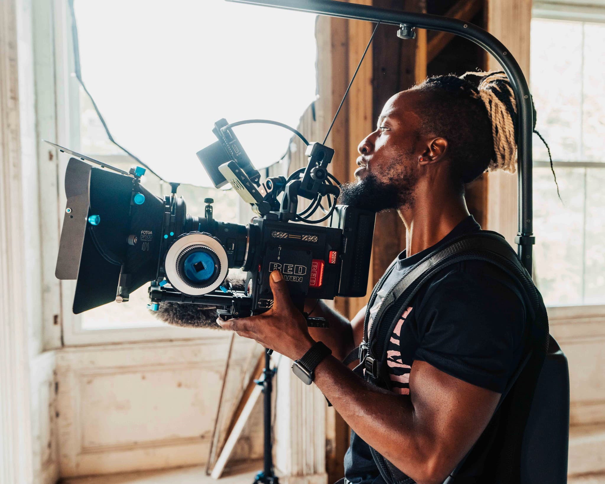 APRT Media artist portrait in a warm, cinematic studio setting